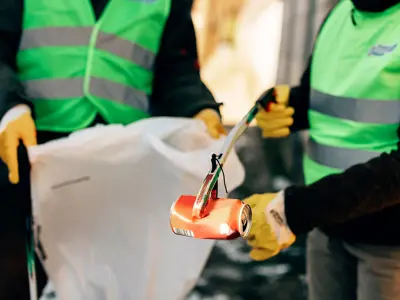 people in PPE cleaning up litter