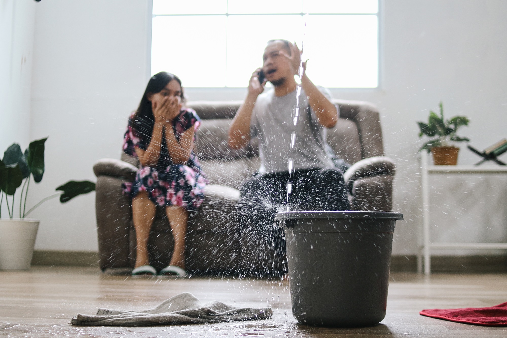 a bucket filling with leaking water