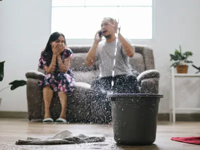 a bucket filling with leaking water