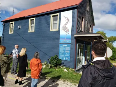 People viewing the Ajiijaak indigenous art installation in Oxenden.