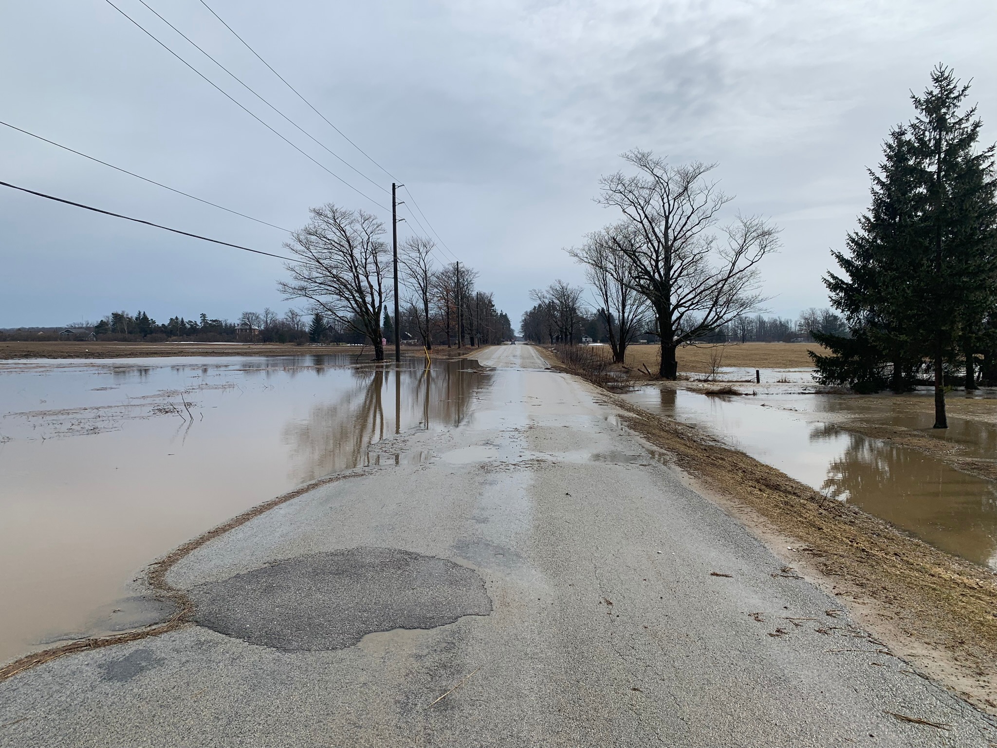A country road flooded with water in spring