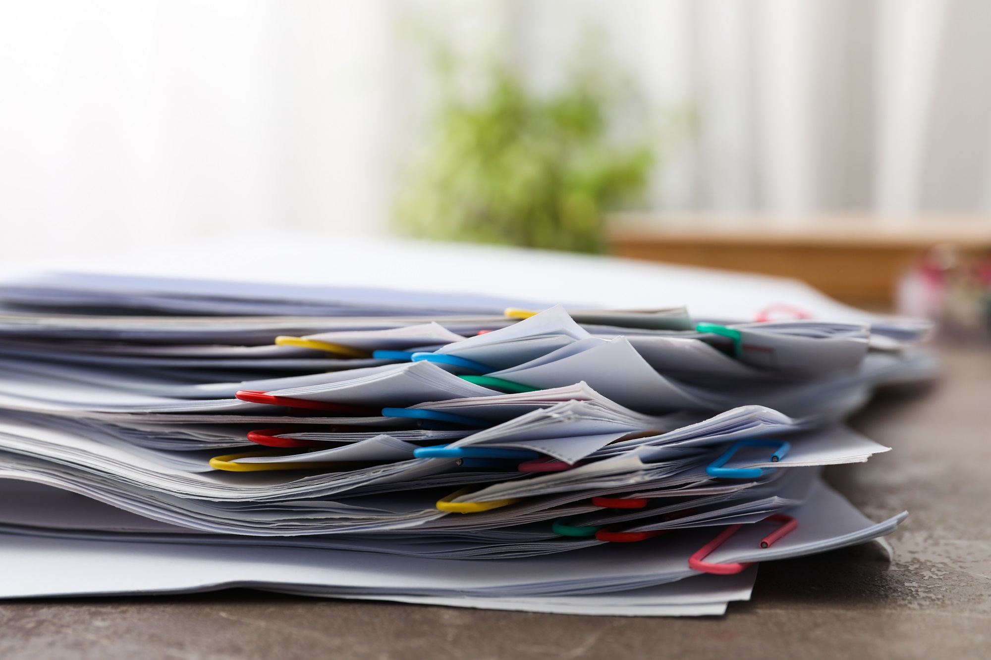 an organized stack of paper files.