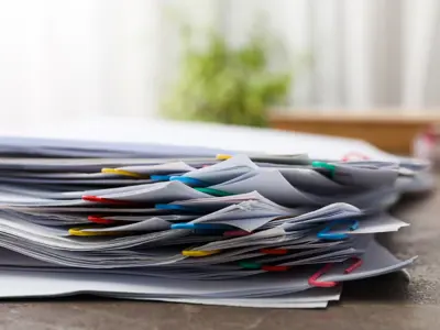 an organized stack of paper files.
