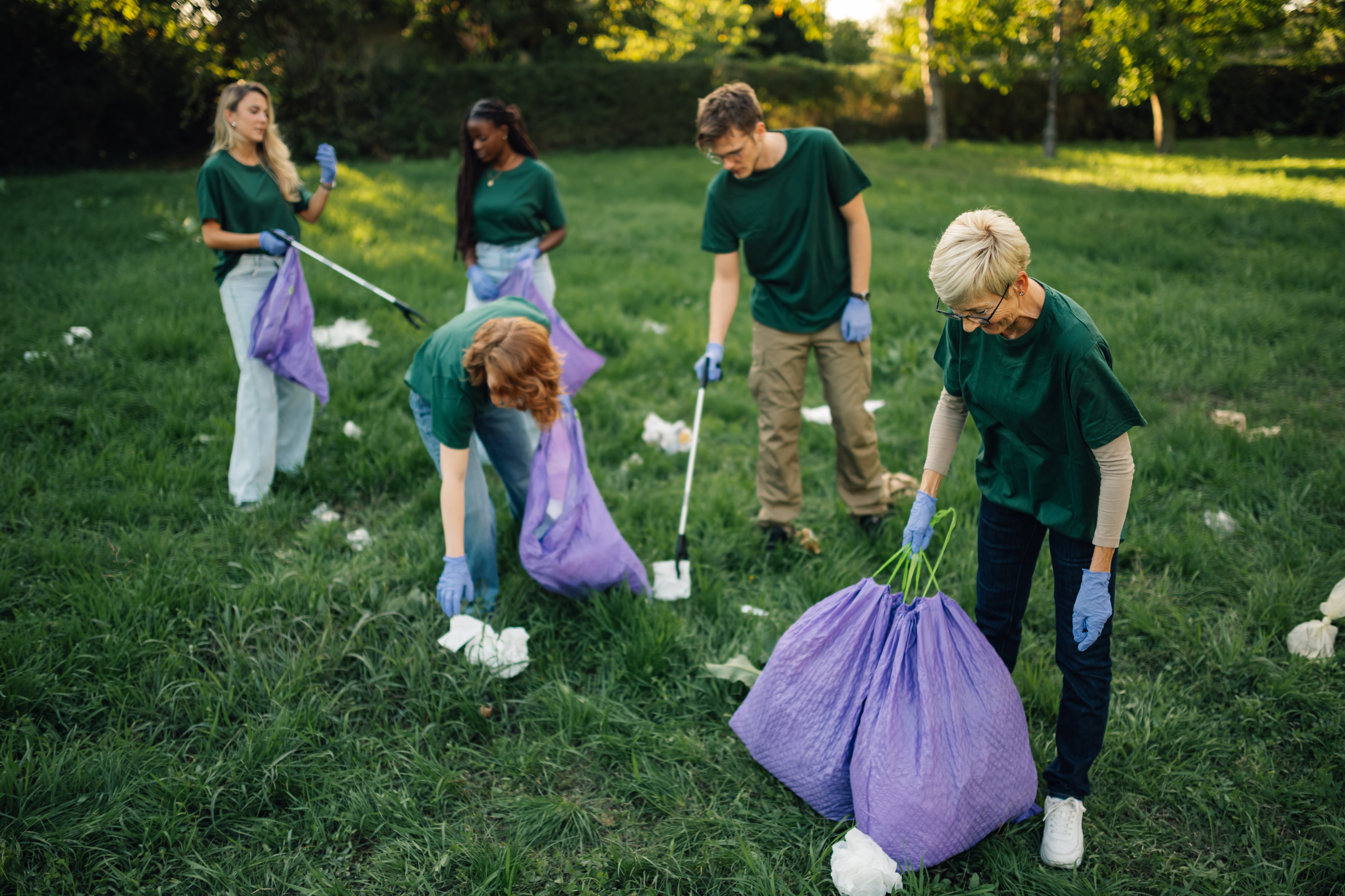 Volunteers Collecting Garbage In Park
